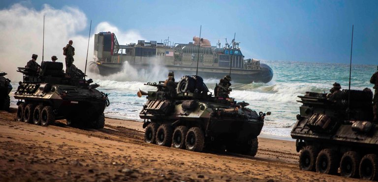 Marines with Battalion Landing Team, 1st Battalion, 6th Marine Regiment, 22nd Marine Expeditionary Unit, convoy their light armored vehicles across the beach as a Navy landing craft, air cushion with Assault Craft Unit 4 departs the beach of Sierra del RetÌn, Spain, during Spanish Amphibious Bilateral Exercise 2014 Feb. 24, 2014. Spanish PHIBLEX is an annual exercise designed to improve interoperability, increase readiness and develop professional and personal relationships between U.S. forces and participating nations. The MEU is deployed to the U.S. 6th Fleet area of responsibility with the Bataan Amphibious Ready Group as a sea-based, expeditionary crisis response force capable of conducting amphibious missions across the full range of military operations. 

(U.S. Marine Corps photo by Sgt. Austin Hazard/Released)
